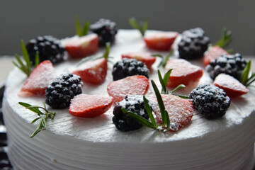 white strawberry-blackberry cake on plate