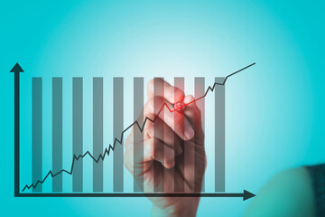 A woman's hand holding a pen Point to the graph, Business growth concept.