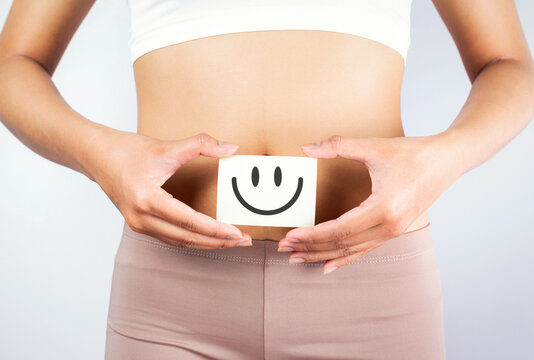 Women Stomach Health. Healthy Female With Beautiful Fit Slim Body  Holding White Card With Happy .Smiley Face In Hands Good Digestion Concepts. High Resolution