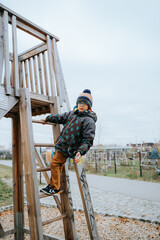 black boy climbs on playground
