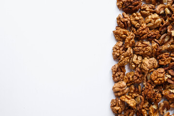 Top view of peeled walnuts placed on a white