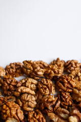 Top view of peeled walnuts placed on a white