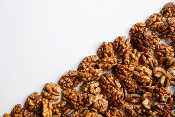 Top view of peeled walnuts placed on a white