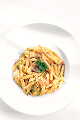 penne amatriciana tomato and ham sauce pasta on white table