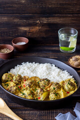 Meatballs with rice, curry sauce, lime and red pepper. Healthy eating.