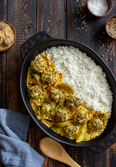 Meatballs with rice, curry sauce, lime and red pepper. Healthy eating.
