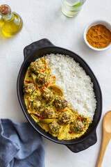 Meatballs with rice, curry sauce, lime and red pepper. Healthy eating.