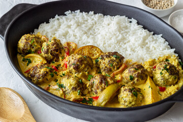 Meatballs with rice, curry sauce, lime and red pepper. Healthy eating.
