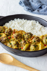 Meatballs with rice, curry sauce, lime and red pepper. Healthy eating.