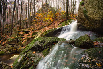 Autumn long exposure of creek Black (Big) Stolpich waterfalls in Jizera Mountain. Water falls into...