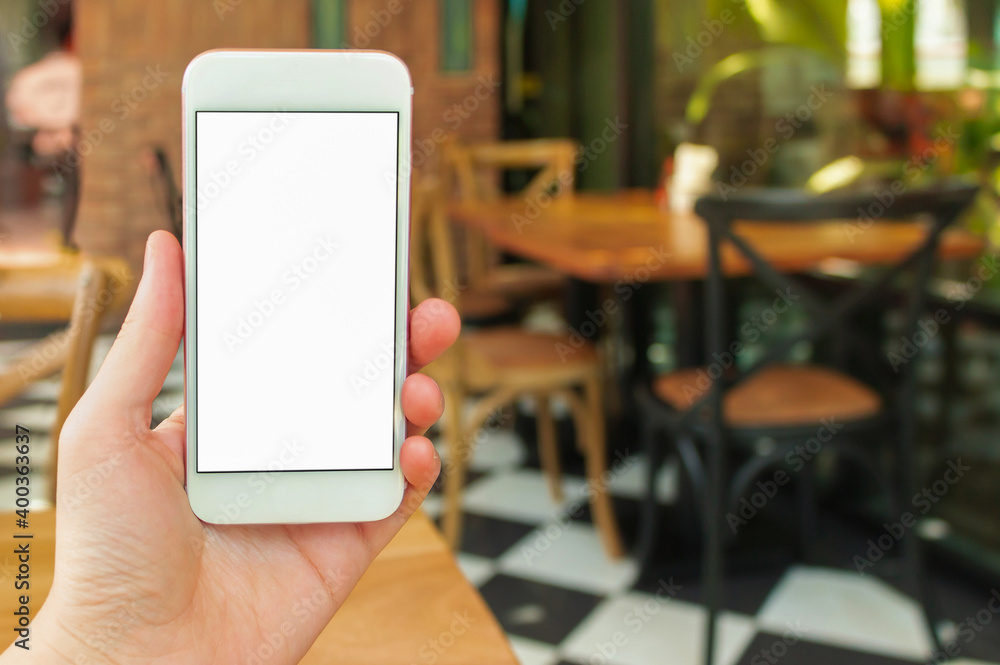Poster white mobile phone woman using the device mockup image in cafe shop ..hands holding with blank scree