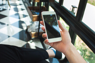 hand use device  white phone  blink screen mobile in cafe modern loft lifestyle