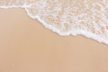 Fototapeta na wymiar Soft smooth waves on the beach.