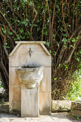 old water fountain, made in nature so that passers-by can rest and refresh themselves with drinking water