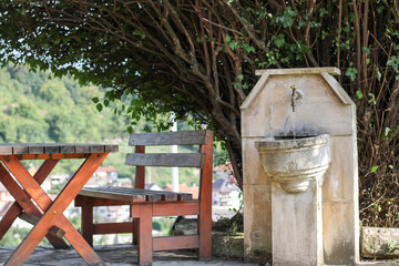 old water fountain, made in nature so that passers-by can rest and refresh themselves with drinking water