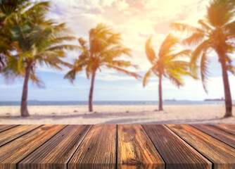 image of Wooden table in front of palm tree blue sea and bright landscape