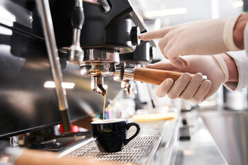 Man touching the controllers at the coffee machine