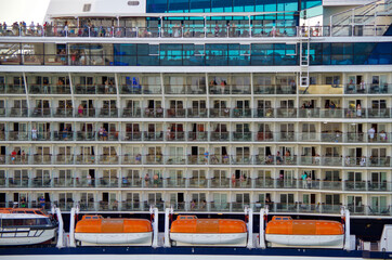 Detail close up view of superstructure with life boats and balcony cabins staterooms of modern...