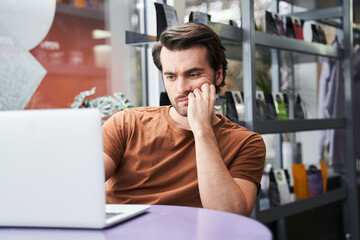 Stressed manager worried about documentation on laptop