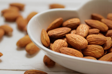 close up piece almond Lowering cholesterol healthy food in a heart-shaped plate