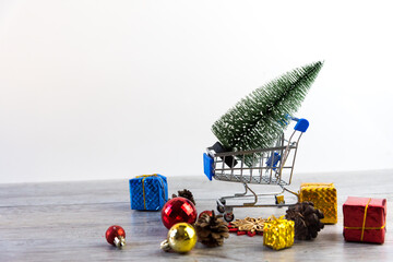 shopping trolley with gifts in Chirstmas shopping. Online shopping concept - trolley cart full of presents for sales in chirstmas, new year holiday in last year.