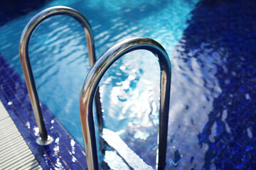 Obraz na płótnie Canvas Grab bars ladder in the swimming pool