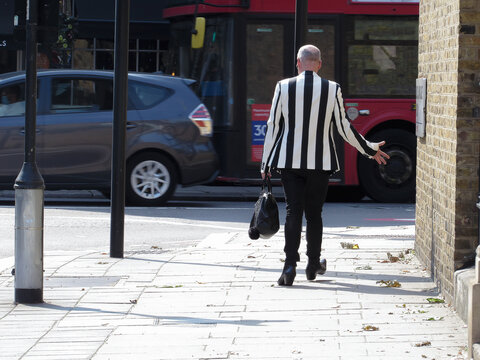 Stylish old gay walks the streets of London     
