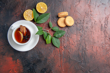 top view cup of tea with lemon and cookies on dark background sweet biscuit cake