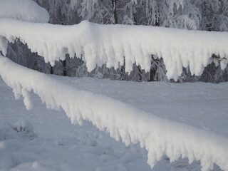 wooden fences are covered with snow and frost