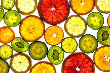 Collage of various fruit slices isolated on a white background.
