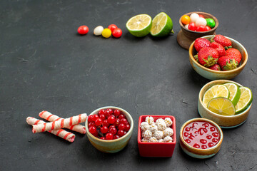 front view fresh lemon slices with candies and fruits on dark background fresh photo color