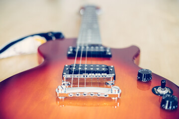 Fototapeta premium Electronic guitar music band rock concept. Guitar in sunburst optic on the floor