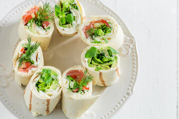 Tasty and homemade tortilla with cheese, vegetables and herbs