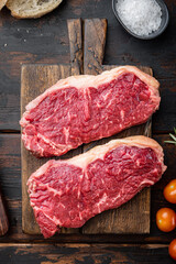 New York steak, raw beef meat , on dark wooden background, top view