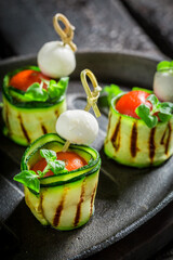 Closeup of finger food made of cheese, tomato and courgette