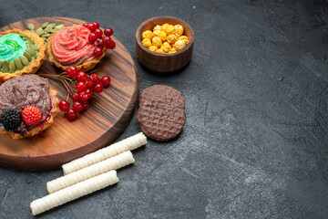 front view yummy creamy cakes with berries on dark backgroun biscuit dessert cookies