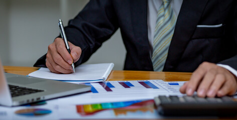 Financial Businessmen analyze the graph of the company's performance to create profits and growth,...