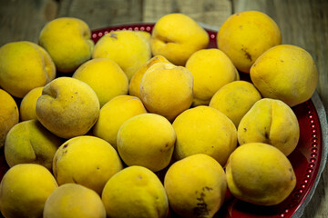 Ripe fresh peach fruits on wooden background
