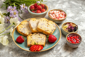 front view yummy cake slices with strawberries on light background fruit sweet cake pie