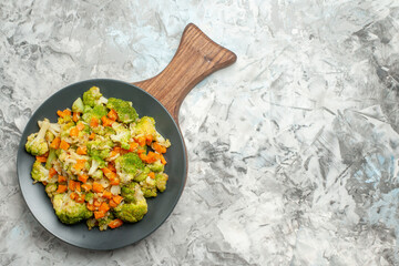 Top view of fresh and healthy vegetable salad on wooden cutting board on white table stock image