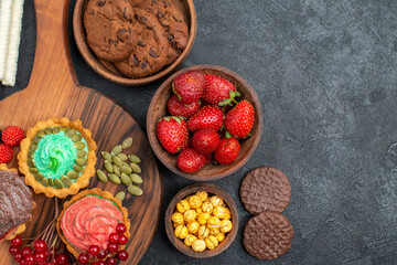 top view tasty creamy cakes with biscuits and fruits on dark background cookies sweet dessert