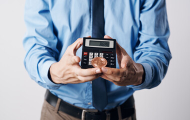 A man holds in his hands a Bitcoin cryptocurrency price increase calculator financial technology