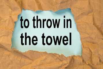 throw in the towel-phrase message through a hole in the crumpled wrapping paper, conceptual image, top view