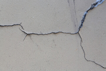 Old wall with cracked plaster. Weathered rough surface. Vintage texture is perfect for background and design.