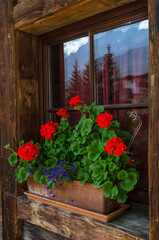 Fototapeta na wymiar Traditional ornamented window in Selva village, Gardena valley, Dolomites, South Tirol, Italy.