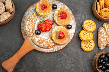 top view tasty pancakes with sweet cakes and fruits on a dark background sugar cake dessert