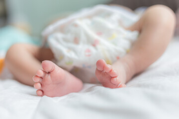 Cute little baby lying on bed New Born Baby Feet