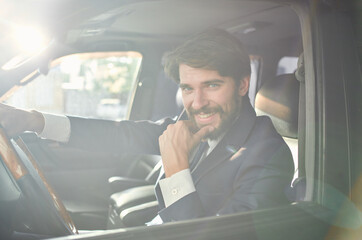 man in a suit driving a car trip road lifestyle passenger