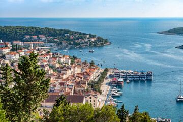 Fototapeta premium Aerial view of the medieval town of Hvar on the island of Hvar, Croatia with a bay, ships, yachts and the nearest islands in the Adriatic sea