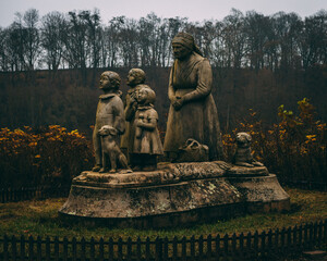 statue of old lady and grandchildren